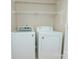 The laundry area provides a washer and dryer with overhead wire shelving for ample storage space at 135 Meadow Lake Dr, Salisbury, NC 28146