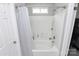 Clean, well-lit bathroom with a shower-tub combo featuring tile surround and a shower curtain at 13612 Bolingbrook Ln, Charlotte, NC 28273