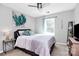 Comfortable bedroom featuring a bed, a ceiling fan, and a side table with a lamp at 13612 Bolingbrook Ln, Charlotte, NC 28273