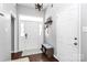 Bright foyer features hardwood floors, fresh paint and a charming bench at 13612 Bolingbrook Ln, Charlotte, NC 28273