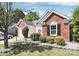 Brick and siding home showcasing professional landscaping around the house and garage at 13612 Bolingbrook Ln, Charlotte, NC 28273