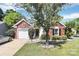 Charming brick and siding home with landscaped front yard and an attached garage at 13612 Bolingbrook Ln, Charlotte, NC 28273