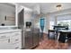 Spacious kitchen featuring stainless steel refrigerator, white cabinets and a breakfast nook with seating at 13612 Bolingbrook Ln, Charlotte, NC 28273
