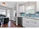 Bright kitchen featuring white cabinets, stainless steel appliances, and a charming breakfast nook with a bay window at 13612 Bolingbrook Ln, Charlotte, NC 28273