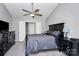 Main bedroom featuring a ceiling fan, neutral carpet, and dark wooden furniture at 13612 Bolingbrook Ln, Charlotte, NC 28273