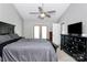 Main bedroom showcasing a ceiling fan, neutral carpet, and French doors leading to the backyard at 13612 Bolingbrook Ln, Charlotte, NC 28273