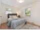 Comfortable bedroom with gray headboard, plush rug, and bright windows at 1422 Burnley Rd, Charlotte, NC 28210