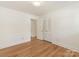 Neutral bedroom with hardwood floors, neutral walls, closet and access to other rooms at 1422 Burnley Rd, Charlotte, NC 28210