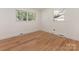 Bright bedroom with hardwood floors, neutral walls, and a large window with tree views at 1422 Burnley Rd, Charlotte, NC 28210