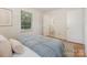 Bright bedroom features a bed, with view into an ensuite bath at 1422 Burnley Rd, Charlotte, NC 28210