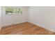 Bright bedroom with hardwood floors and a large window with tree views at 1422 Burnley Rd, Charlotte, NC 28210