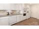 Well-lit kitchen featuring white cabinetry, complementing backsplash, and modern appliances at 1422 Burnley Rd, Charlotte, NC 28210