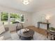 Well-lit living room featuring wood floors and a view to the entry at 1422 Burnley Rd, Charlotte, NC 28210
