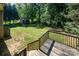 A lush backyard with a shed, a deck, a wooden fence, and mature trees at 154 Seven Oaks Ln, Statesville, NC 28677