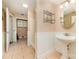 A bathroom features a tile floor, a pedestal sink, a shower, and convenient shelving for organization at 154 Seven Oaks Ln, Statesville, NC 28677