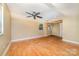 A spacious bedroom featuring hardwood floors, a ceiling fan, and natural light from the window at 154 Seven Oaks Ln, Statesville, NC 28677
