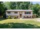 Inviting home featuring a well-manicured lawn, front entrance, and stairs to the side entry at 154 Seven Oaks Ln, Statesville, NC 28677