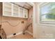 A practical laundry area with wall-mounted cabinets and a window for natural light at 154 Seven Oaks Ln, Statesville, NC 28677