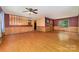 Spacious living room showcasing hardwood floors, wainscoting, and a ceiling fan at 154 Seven Oaks Ln, Statesville, NC 28677