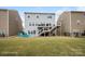 Expansive backyard with a well-manicured lawn and an elevated deck accessible by stairs at 16038 Harbor Hill Dr, Charlotte, NC 28273