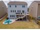 Spacious backyard featuring a patio with seating, a fire pit area and a multi-level deck perfect for entertaining and relaxation at 16038 Harbor Hill Dr, Charlotte, NC 28273
