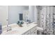 Bathroom featuring a double sink vanity, white cabinets, and a shower with a floral curtain at 16038 Harbor Hill Dr, Charlotte, NC 28273