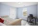Bedroom featuring a bed, window, closet, and desk, with blue walls and neutral carpet at 16038 Harbor Hill Dr, Charlotte, NC 28273
