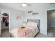 Bright bedroom features soft blue walls, plush carpet, and a comfortable bed with a pink throw at 16038 Harbor Hill Dr, Charlotte, NC 28273