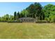 Inviting community entrance featuring a stone sign, manicured landscaping, and lush trees, creating a welcoming atmosphere at 16038 Harbor Hill Dr, Charlotte, NC 28273