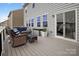 Relaxing deck with a cushioned wicker sofa set, matching storage box and an outdoor patio, for comfortable outdoor living at 16038 Harbor Hill Dr, Charlotte, NC 28273