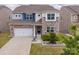 Inviting two-story home with a stone and siding exterior, well-manicured lawn, and a two-car garage at 16038 Harbor Hill Dr, Charlotte, NC 28273