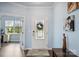 Bright foyer featuring a decorative front door, wood floors, and view to office at 16038 Harbor Hill Dr, Charlotte, NC 28273