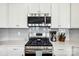 Close up on stainless steel range and backsplash in the kitchen at 16038 Harbor Hill Dr, Charlotte, NC 28273