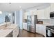 Kitchen with island, stainless steel appliances, and white cabinetry at 16038 Harbor Hill Dr, Charlotte, NC 28273