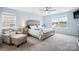 Serene main bedroom with a large bed, sitting area, and plenty of natural light at 16038 Harbor Hill Dr, Charlotte, NC 28273
