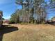 A spacious backyard with mature trees and a view of the adjacent property offers privacy and serenity at 16446 Doves Canyon Ln, Charlotte, NC 28278