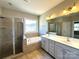 A full bathroom with a double vanity, a separate shower, and a large soaking tub at 16446 Doves Canyon Ln, Charlotte, NC 28278