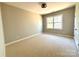 Spacious bedroom with neutral carpet, large window providing natural light, and a ceiling fan at 16446 Doves Canyon Ln, Charlotte, NC 28278