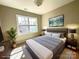 A staged bedroom with a modern bed and a large window allowing for natural light at 16446 Doves Canyon Ln, Charlotte, NC 28278