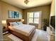 Comfortable bedroom features a queen bed with a soft rug, dresser, and a window that provides natural light at 16446 Doves Canyon Ln, Charlotte, NC 28278