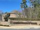 The Bear Creek community entrance is marked by a brick wall, stone accents, and mature landscaping at 16446 Doves Canyon Ln, Charlotte, NC 28278