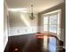 Well-lit dining room with hardwood floors, decorative wall trim, and a large bay window providing natural light at 16446 Doves Canyon Ln, Charlotte, NC 28278
