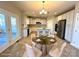 Open-concept kitchen with an island, stainless steel appliances, and stylish dining area for a modern and functional space at 16446 Doves Canyon Ln, Charlotte, NC 28278