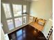 Spacious living room featuring high ceilings, lots of windows, hardwood floors, and an open layout to the kitchen at 16446 Doves Canyon Ln, Charlotte, NC 28278