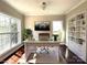 Bright home office featuring a large desk, modern lighting, and ample natural light with two large windows and built in shelving at 16446 Doves Canyon Ln, Charlotte, NC 28278