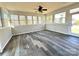 The sunroom features luxury vinyl plank floors and multiple windows that flood the space with natural light at 16446 Doves Canyon Ln, Charlotte, NC 28278