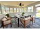 Inviting sunroom with tile flooring, a modern dining set, and multiple windows that flood the space with natural light at 16446 Doves Canyon Ln, Charlotte, NC 28278