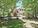 The backyard features a brick chimney, brick accents, and a spacious grass area at 16511 Bridgehampton Club Dr, Charlotte, NC 28277
