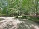 Home showcasing a beautiful backyard with a wooded area at 16511 Bridgehampton Club Dr, Charlotte, NC 28277