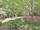 Home showcasing a beautiful backyard with a wooded area at 16511 Bridgehampton Club Dr, Charlotte, NC 28277